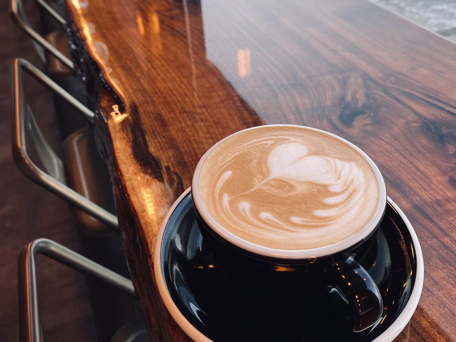 A latte on the live-edge counter