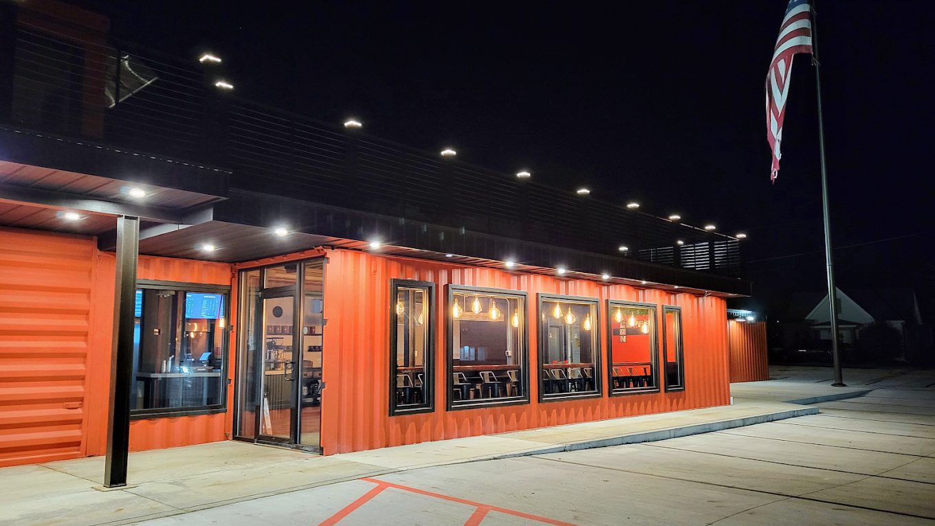 The lit container building and its windows after dark
